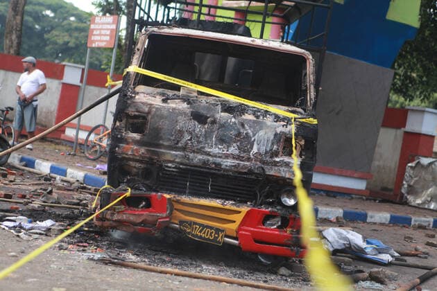 (221002) -- MALANG, Oct. 2, 2022 -- Photo taken on Oct. 2, 2022 shows the wreckage of a burned truck outside the Kanjuruhan Stadium in Malang of East Java province, Indonesia. At least 129 people were killed and 180 others injured after a stampede and clashes at a football match in Indonesia s Malang, East Java province on Saturday evening, Indonesian police said on Sunday. Provincial police chief Nico Afinta said at a press conference that the chaos happened on late Saturday at the Kanjuruhan Stadium in Malang regency right after Arema Malang club lost to Persebaya Surabaya in the Indonesian Liga 1 football contest. (Photo by Xinhua) INDONESIA-MALANG-FOOTBALL MATCH-STAMPEDE-CLASH-CASUALTIES BayuxNovanta 
