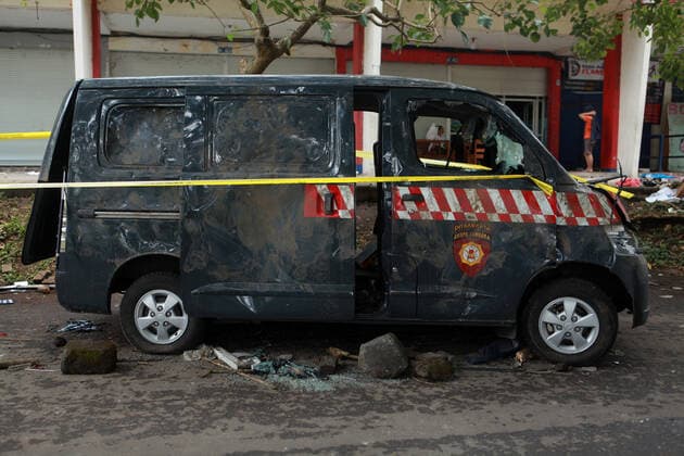 (221002) -- MALANG, Oct. 2, 2022 -- Photo taken on Oct. 2, 2022 shows the wreckage of a destroyed vehicle outside the Kanjuruhan Stadium in Malang of East Java province, Indonesia. The death toll in a crowd stampede at a football match in Indonesia s East Java province has reached 174 as of Sunday afternoon, according to the province s deputy governor Emil Dardak. The tragedy occurred on Saturday night at the Kanjuruhan Stadium in Malang of Indonesia s East Java province, right after Arema Malang club lost to Persebaya Surabaya in an Indonesian league football match. (Photo by Xinhua) INDONESIA-MALANG-FOOTBALL MATCH-STAMPEDE BayuxNovanta 