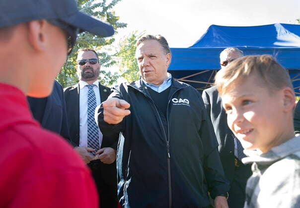 October 2, 2022, Magog, PQ, Canada: Coalition Avenir Quebec Leader Francois Legault talks with two young boys during an election campaign stop at a market in Magog, Que., Sunday, October 2, 2022. Quebecers will go to the polls on Monday. Magog Canada  - ZUMAc35_ 20221002_zaf_c35_012 Copyright: xGrahamxHughesx
