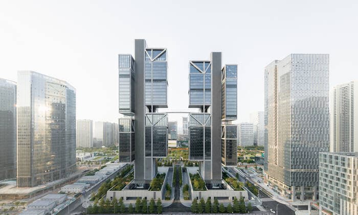 **VIDEO AVAILABLE: CONTACT INFO@COVERMG.COM TO RECEIVE** British architecture studio Foster + Partners has completed two skyscrapers - connected by an open-air suspension bridge, 105 meters above the ground - for Chinese drone manufacturer DJI in Shenzhen called DJI Sky City. DJI Sky City in Shenzen is comprised of the two 200-metre-high skyscrapers that now house the the robotics company and drone specialists DJI. The bridge is attached to each of the towers by vertically slatted cores, which both support a series of steel truss-encased, glass volumes that were stacked and cantilevered on top of one another. Its ground floor houses public facilities, including a community healthcare centre, and lobbies that each contain an indoor zen g Copyright: xx 52040755 EDITORIAL USE ONLY. NOT FOR USE BY NEWSPAPERS BASED IN THE UK.