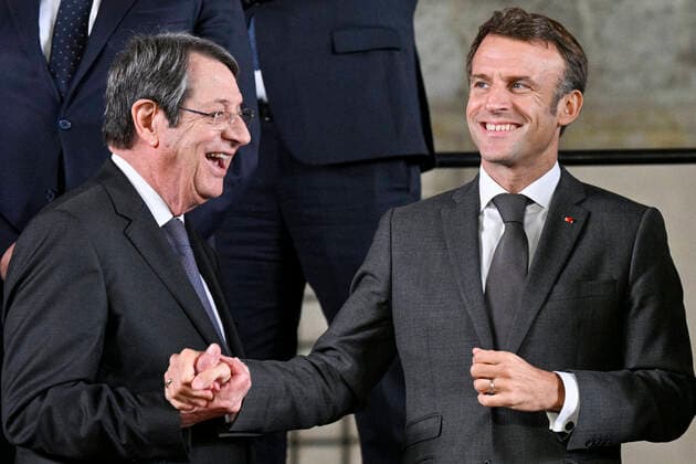 Cypriot President Nikos Anastasiadis (left) and French President Emmanuel Macron laugh at the first meeting of European Political Community (EPC), new political grouping, on October 6, 2022, at the Prague Castle, Czech Republic. (CTKxPhoto VitxSimanek) CTKPhotoP2022100607079 
