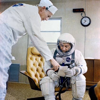 RECORD DATE NOT STATED (23 March 1965) --- Astronaut Virgil I. Grissom, command pilot of the Gemini-Titan 3 space flight, is shown in the suiting trailer at Pad 16 going over a checklist with suit technician Joe Schmitt. 1062_36_M_-1014-