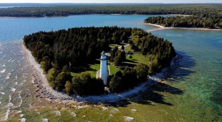 September 30, 2022, WISCONSIN, USA: The Cana Island Lighthouse on the north tip of Spike Horn Bay is located at 8800 E Cana Island Rd Baileys Harbor, Wisconsin. In 2019 the structure celebrated 150 years of standing watch on the shore of Lake Michigan. Ride a hay-wagon over the causeway to explore the island, including the 89-foot-tall light tower, oil storage house and lighthouse keeperÃ¢â‚¬â ¢s home. The highlight of any Cana Island visit is climbing the 97 steps of the towerÃ¢â‚¬â ¢s spiral staircase to reach the gallery deck, which delivers a sweeping panoramic view of Lake Michigan and the Door County peninsula. Open 10am-5pm, May-October. USA - ZUMAs101 20220930_zap_s101_007 Copyright: xKevinxE.xSchmidtx