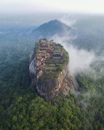 Sigiriya Rock In Sri Lanka An Aerial View of Sigiriya Rock on October 10, 2022 in Dambulla, Sri Lanka. Sigiriya Lion Rock is an ancient rock fortress known for its massive column of rock that reaches nearly 200 meters high. The site dates back to the reign of King Kasyapa (477 495 AD), who chose this site as his new capital. He decorated the walls with frescoes and built an impressive palace right on top of the rock column, accessible only through the mouth of an enormous carved lion. It is located at a distance of 178 km from Colombo and has become a popular tourist spot for foreigners from all over the world. Dambulla Sri Lanka  Copyright: xThilinaxKaluthotagex originalFilename: kaluthotage-notitle221010_npARB.jpg