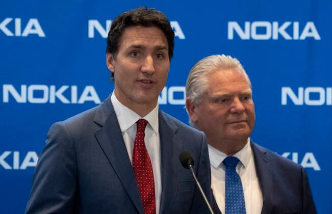 October 17, 2022, Ottawa, ON, Canada: Ontario Premier Doug Ford looks on as Prime Minister Justin Trudeau responds to a question following an announcement in Ottawa, Monday, Oct. 17, 2022. Ottawa Canada  - ZUMAc35_ 20221017_zaf_c35_012 Copyright: xAdrianxWyldx