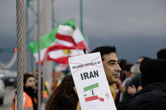 October 29, 2022, Vancouver, British Columbia, Canada: A person holds a sign agains the Islamic Republic of Iran during a protest in Vancouver, British Columbia...The protest brought people together on the Lions Gate Bridge to form a human chain protesting the current Iranian government. Vancouver Canada - ZUMAw171 20221029_znp_w171_009 Copyright: xRyanxWalterxWagnerx