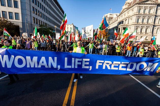 October 29, 2022, Washington, DC, United States: The lead banner of a march for Mahsa (Zhina) Amini, the young woman who died in custody of Iran s morality police. The event was one of many worldwide in which a human chain was formed in solidarity with protesters in Iran. The protests that continue into their seventh week pose the greatest threat to the Islamic regime in decades. Washington United States - ZUMAs197 20221029_zaa_s197_706 Copyright: xAllisonxBaileyx