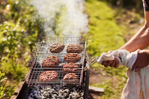 Hand s of man cooking burger patties in backyard model released, Symbolfoto, ONAF00097
