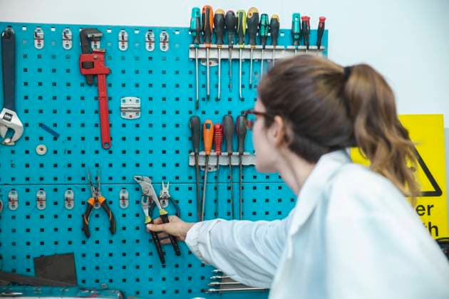 Technician removing work tool from rack in workshop model released, Symbolfoto property released, PCLF00025
