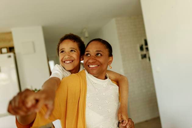 Happy boy embracing mother from behind at home model released, Symbolfoto property released, VIVF00038