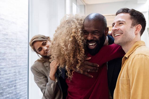 Happy business people hugging in office model released, Symbolfoto property released, WESTF25002