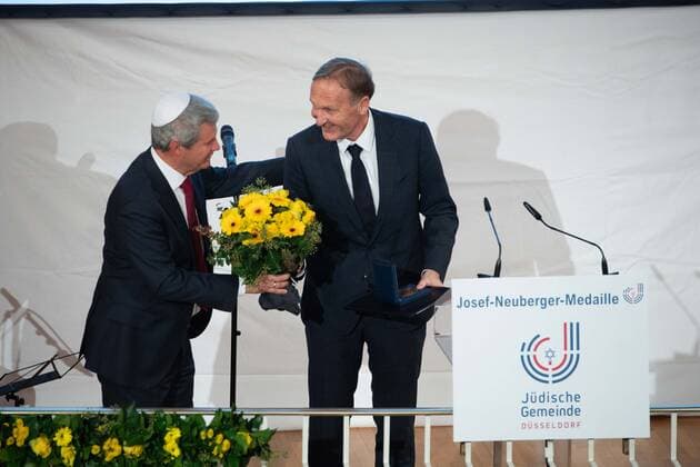 Preistraeger Hans Joachim WATZKE, mit der Josef Neuberger-Medaille, links gratuliert Dr. Oded HOROWITZ, Vorsitzender der juedischen Gemeinde Duesseldorf, mit Blumen, Verleihung der Josef Neuberger-Medaille 2022 der juedischen Gemeinde Duesseldorf an Hans Joachim Watzke, 03.11.2022