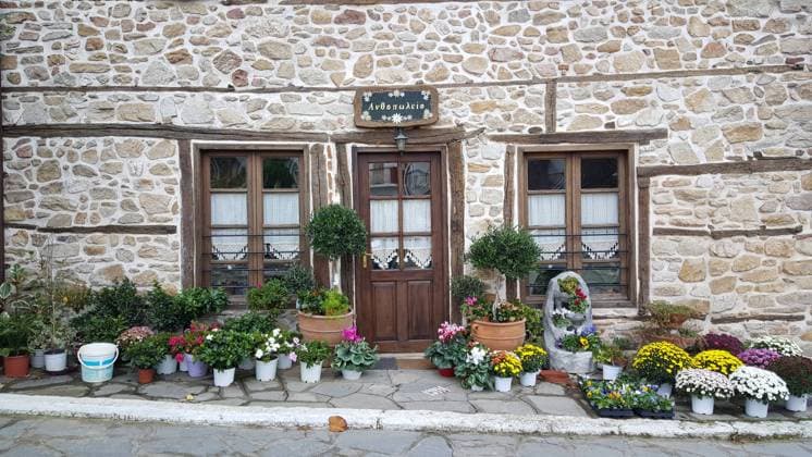 RECORD DATE NOT STATED Flower in front of a house in Arnaia in Chalkidiki, Greece , 35127358.jpg, Door, window, flower, plant, stone, town, House, Arnaia, Chalkidiki, Greece, Europe, landscape, village, street