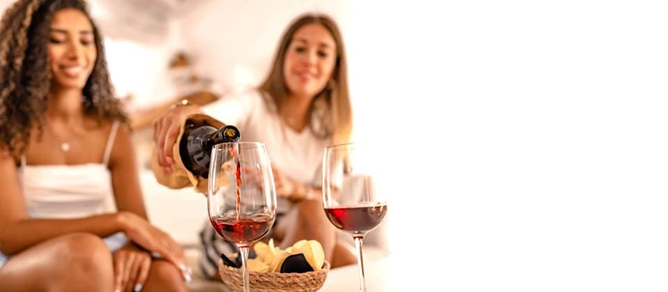 RECORD DATE NOT STATED Two happy female friends celebrating at home pouring red wine in the glasses in selective focus effect and copy space. Young Caucasian woman toasting with her best Hispanic friend drinking alcohol, model released, , property released, , 35335182.jpg, glasses, friends, wine, red, people, home, happy, black, conversation, african-american, women, woman, african, american, young, toast, event, beautiful, birthday, glass, hand, party, summer, female, girlfriends, tasting, italy, drinking, girls, living, house, room, couch, apartment, attractive, comfortable, indoors, sofa, alcohol, cheers, girl, hipster, couple, lifestyle, reunion, meeting, leisure, person, latin, sitting