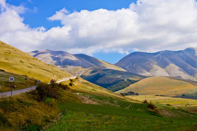 RECORD DATE NOT STATED National Park of the Sibillini Mountains. Fields in Castelluccio di Norcia, Umbria, Italy. October 2019. , 35461702.jpg, fields, landmark, sibillini, cloud, mountain, relax, national park, view, italia, tourism, clouds, scenery, grass, scenic, beautiful, sky, environment, landscape, travel, blue, hill, outdoor, italian, countryside, nature, green, park, meadow, italy, umbria, agriculture, summer, norcia, field, panorama, natural, castelluccio, rural, europe, outdoors, lentils, flower, perugia, mountains, castelluccio di norcia, valley, hills