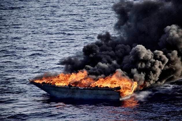 A makeshift boat set on fire by the Libyan coast guard, after they intercepted it and recovered survivors on board to take them back to Libya. Back there, the migrants are placed in detention centers where their fundamental rights are not respected.  AntoninxBuratx xLexPictorium LePictorium_0270052