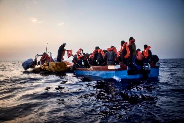 Rescuers of SOS Mediterranee distributing life jackets to 67 migrants in a distressed boat departed from Zuwarah and spotted several hours before dawn.  AntoninxBuratx xLexPictorium LePictorium_0270059
