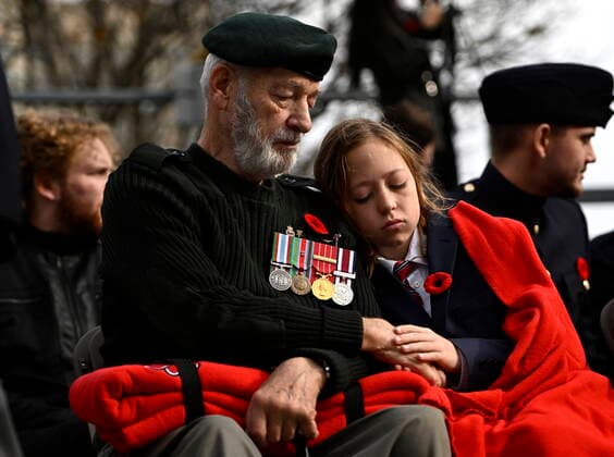 November 11, 2022, Ottawa, ON, CAN: Mason Johnson, 13, holds the hand of his grandfather, veteran David Haase, who served as a military engineer in the Canadian Forces, during the National Remembrance Day Ceremony at the National War Memorial in Ottawa, on Friday, Nov. 11, 2022. Ottawa CAN  - ZUMAc35_ 20221111_zaf_c35_047 Copyright: xJustinxTangx