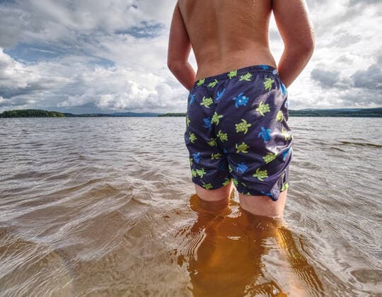 RECORD DATE NOT STATED Little joyful Caucasian funny boy try cold water of lake. Kid stay in water with level at knee, model released, , 36931044.jpg, boy, caucasian, cheer, child, childhood, cold water, cold weather, cooling, cowards, droplet, dynamic, enthusiasm, expression, floundering, happiness, hard, holiday, hot, joy, kid, knee, lad, lake, laughing, lonely, low angle view, low view, natural, play, pond, poor, rest, river, sand, scenic, seashore, smile, son, splash, summer, summertime, sunbeam, swim, swimmer, swimming pants, swimming shorts, swimming suit, try, vitality, water