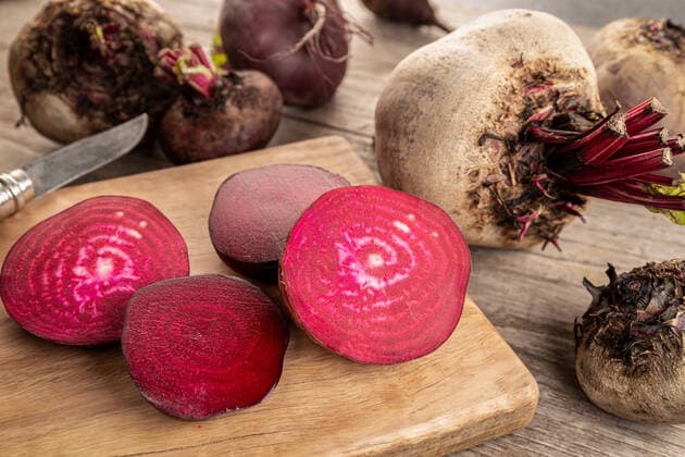 Organic Red beet root on wooden table Organic Red beet root on wooden table. Beta vulgaris Copyright: xZoonar.com AndresxVictorerox 15924017