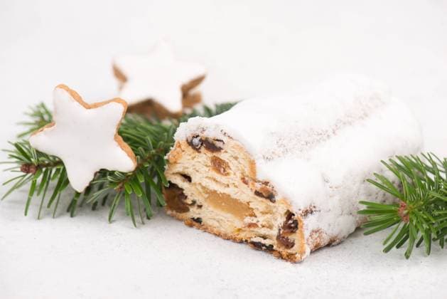 Christstollen, traditonal christmas cake with nuts, raisons, marzipan on a blue background, empty Christstollen, traditonal christmas cake with nuts, raisons, marzipan on a blue background, empty space for text Copyright: xZoonar.com BeritxKesslerx 18596430