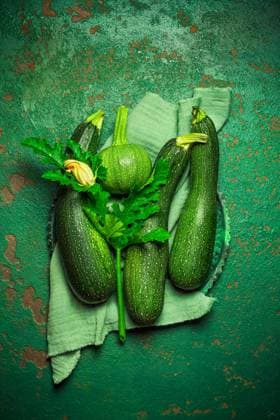 Assortment of organic courgettes and zucchinis on green background Assortment of organic courgettes and zucchinis on green background Copyright: xZoonar.com IngridxBalabanovax 19075556