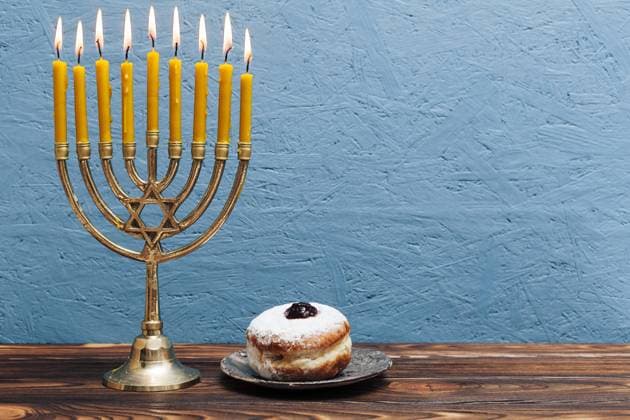 jewish menorah with tasty donut jewish menorah with tasty donut Copyright: xZoonar.com OleksandrxLatkunx 17742627