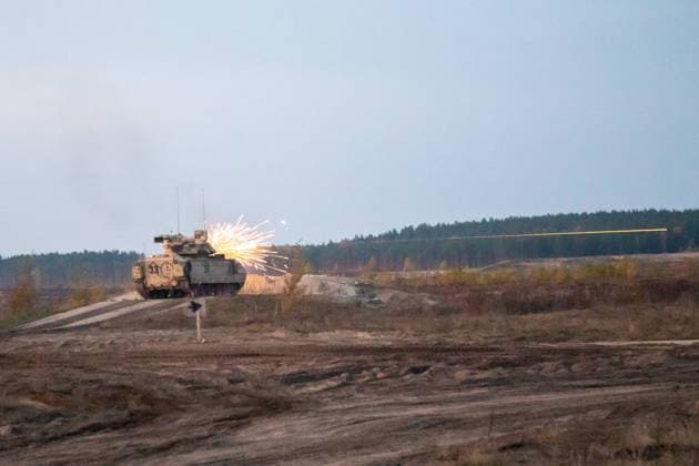 U.S. Army Soldiers assigned to Cutthroat Company, 1st Battalion, 66th Armor Regiment, 3rd Armored Brigade, 4th Infantry Division (3-4 ABCT) engage enemy targets with an M2 Bradley Fighting Vehicle during a platoon live-fire exercise at PabradÄ— Training Area, Lithuania, Oct. 13, 2022. The 3-4 ABCT is among other units assigned to the 1st Infantry Division, proudly working alongside NATO allies and regional security partners to provide combat-credible forces to V Corps, America s forward deployed corps in Europe.