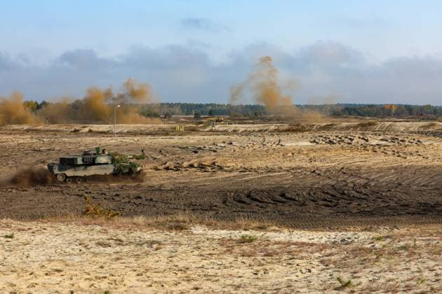 U.S. Army M2A3 Bradley Fighting Vehicle assigned to 1st Battalion, 68th Armor Regiment, 3rd Armored Brigade Combat Team, 4th Infantry Division and a Polish army Leopard tank moves under smoke concealment to the attack position during a multinational live fire at Borsuk 22, Nowa Deba, Poland, Oct. 14, 2022. (3-4 ABCT) The 3-4 ABCT is among other units assigned to the 1st Infantry Division, proudly working alongside NATO allies and regional security partners to provide combat-credible forces to V Corps, America s forward deployed corps in Europe.