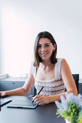 Smiling young designer with graphic tablet sitting at office model released, Symbolfoto property released, PNAF04592
