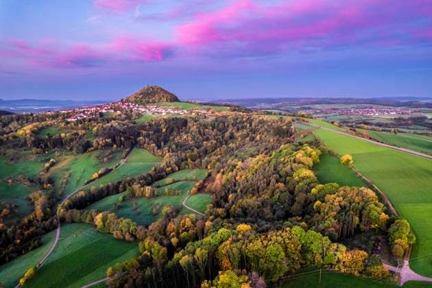 Germany, Baden-Wurttemberg, Drone view of autumn grove at moody dusk with Hohenstaufen mountain in distant background, STSF03583