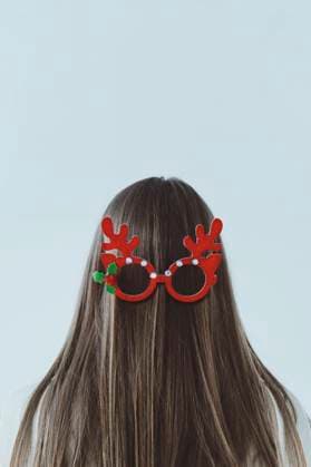 Creative Highlights Symbolbilder Girl with long hair wearing reindeer antler glasses on back of head model released, Symbolfoto, IEF00252