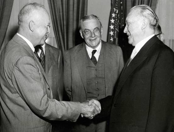 US President Dwight Eisenhower shake hands with Chancellor of the Federal Republic of Germany Konrad Adenauer while US Secretary of State John Foster Dulles looks on, Washington, DC, USA 1955 