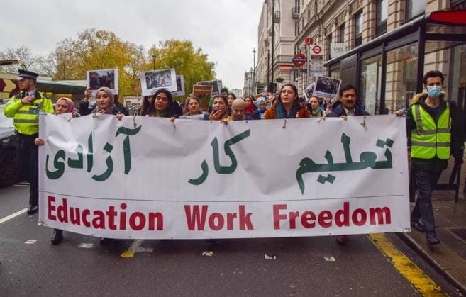 November 27, 2022, London, England, United Kingdom: Protesters in Piccadilly march with an Education, work, freedom banner. People marched through central London in support of women s and girlsÃ¢â‚¬â ¢ rights in Afghanistan and in response to reports that the Taliban government continues to impose oppressive laws targeting women and girls, and restricts access to education. London United Kingdom - ZUMAv130 20221127_zip_v130_010 Copyright: xVukxValcicx