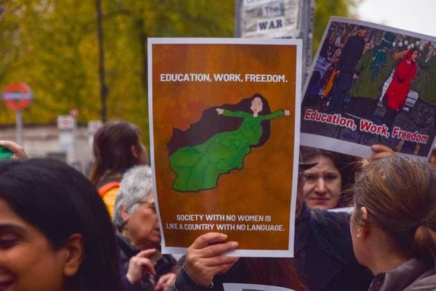 November 27, 2022, London, England, United Kingdom: A protester in Piccadilly holds an Education, work, freedom sign. People marched through central London in support of women s and girlsÃ¢â‚¬â ¢ rights in Afghanistan and in response to reports that the Taliban government continues to impose oppressive laws targeting women and girls, and restricts access to education. London United Kingdom - ZUMAv130 20221127_zip_v130_011 Copyright: xVukxValcicx