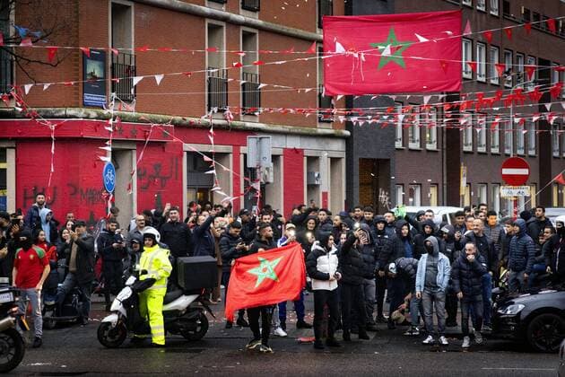 THE HAGUE - Moroccan football fans celebrate at the Hoefkade after the national team won the World Cup against Belgium. Where the neighborhood turns completely orange in most streets, there is also a lot of red and green, from the flag of Morocco. ANP RAMON VAN FLYMEN netherlands out - belgium out
