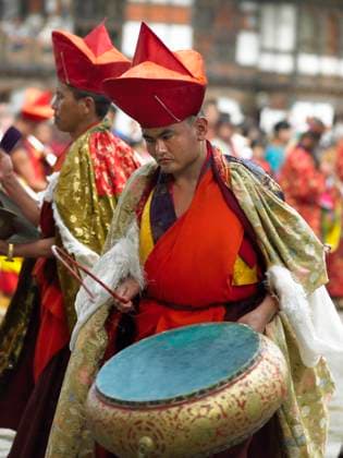 RECORD DATE NOT STATED Paro Buddhist Tsechu at Paro Dzong in the Kingdom of Bhutan. , 9590064.jpg, tourism, ethnic, asia, local, asian, bhutanese, travel, man, male, people, kingdom, paro, diversity, bhutan, Kingdom of Bhutan, Paro Tsechu, festival, tsechu, drum, drumming, drummer, culture, cultural, Buddhism, Buddhist, religious, religion, Paro Dzong, dzong, monastery,