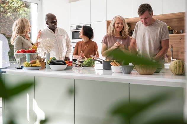 RECORD DATE NOT STATED Diverse group of friends having a good time in the kitchen while getting ready to eat Copyright: EricxAudras B75721946