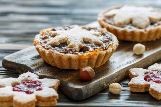 Cakes with dried fruits, orange jam and nuts. Christmas cakes with dried fruit and nuts on wooden table, selective focus. Copyright: xZoonar.com MarinaxSaprunovax 11582846