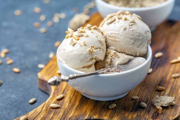 Ice cream with halva and sunflower seeds close up. Homemade sundae with sunflower oil and halva in a white ceramic bowl close-up, selective focus. Copyright: xZoonar.com MarinaxSaprunovax 14093050