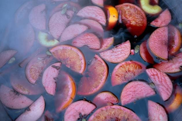 RECORD DATE NOT STATED closeup of mulled wine, preparing in big old metal kettle on fire, above view, Traditional Christmas fair market beverage , 35320738.jpg, mulled wine, preparation, seasons, warmth, favor, booze, mood, wine, warm, punch, relax, smoke, apple, prepare, seasonal, boiler, heat, steam, seasoning, xmas, adding, citron, condiment, festive, flavor, piece, christmas, drink, alcohol, holiday, hot, spice, pot, pan, cinnamon, slice, making, red, anise, aromatic, cosiness, grog, metal, beverage, fruit, traditional, winter, cooking, mulled