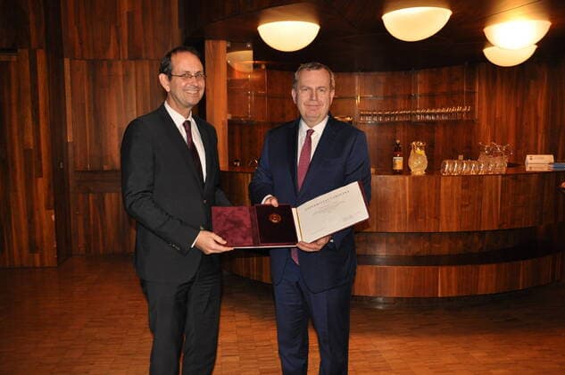 Former German ambassador to Czechia Christoph Israng (left) receives Charles University Prague s golden medal at Czech embassy in Berlin from former Charles University Rector Tomas Zima in Berlin, Germany, December 8, 2022. (CTKxPhoto AlesxZapotocky) CTKPhotoP2022120806247  P2022120806247