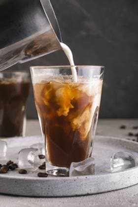 milk pouring into glass with coffee. High quality and resolution beautiful photo concept milk pouring into glass with coffee. Resolution and high quality beautiful photo Copyright: xZoonar.com OleksandrxLatkunx 17851479