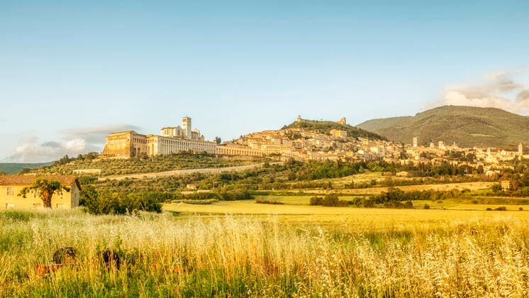 RECORD DATE NOT STATED An image of a view to Assisi in Italy Umbria at the evening , 22270784.jpg, assisi, italy, panorama, umbria, old, landscape, meadow, sunset, town, church, medieval, green, basilica, sky, travel, spring, season, architecture, building, ancient, cloud, history, scenic, religion, saint, dusk, roman, beautiful, view, nature, blue, panoramic, june, tree, outdoor, tourism, horizontal, culture, urban, construction, europe, rural, country, mountain, landmark, religious, famous, nobody, copy space, golden