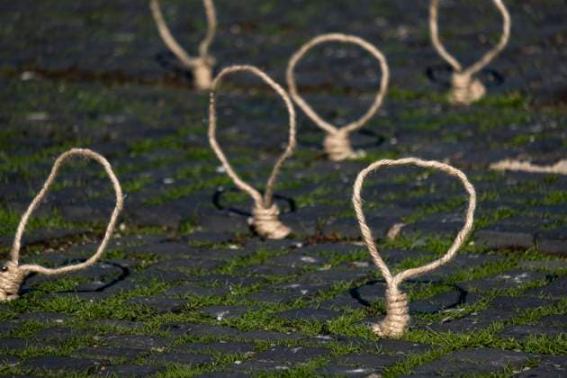 December 10, 2022, Barcelona, Catalonia, Spain: Gallows ropes are seen planted by protesters on the grass of Plaza Catalunya during the demonstration. Coinciding with Human Rights Day, hundreds of demonstrators have demonstrated in the center of Barcelona to protest against the repression of the Iranian regime and against the death sentences of those detained during the demonstrations. Barcelona Spain - ZUMAs197 20221210_zaa_s197_128 Copyright: xPacoxFreirex