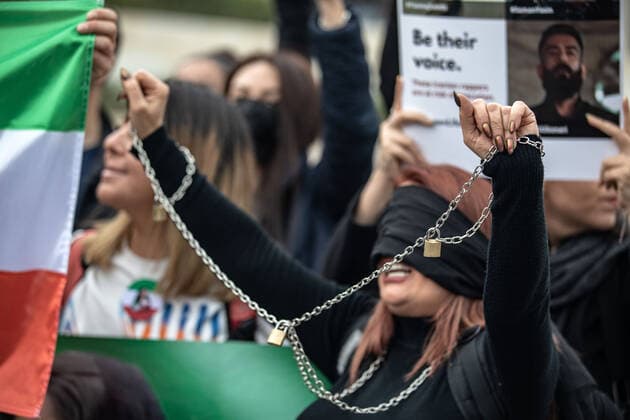 December 10, 2022, Istanbul, Turkey: A protester covered her face with black tape while holding chains during the demonstration. Mahsa Amini s death has sparked weeks of violent protests across Iran and other countries. Mahsa fell into a coma and died after being arrested in Tehran by the morality police for allegedly violating the country s hijab rules. In the trials regarding the protests, 11 people have been sentenced to death so far. Istanbul Turkey - ZUMAs197 20221210_zaa_s197_160 Copyright: xOnurxDogmanx
