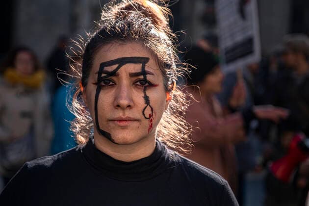 December 10, 2022, Barcelona, Catalonia, Spain: A woman with a gallows drawn on her face seen during the demonstration. Coinciding with Human Rights Day, hundreds of demonstrators have demonstrated in the center of Barcelona to protest against the repression of the Iranian regime and against the death sentences of those detained during the demonstrations. Barcelona Spain - ZUMAs197 20221210_zaa_s197_140 Copyright: xPacoxFreirex