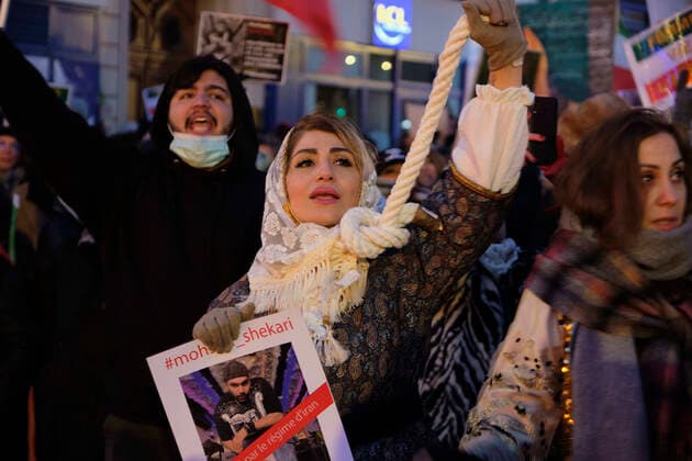 December 11, 2022, Paris, Ile de France, FRANCE: A woman holding a noose around her neck participates in a march in Paris to denounce the Islamic regime in Iran. Mohsen Shekari was the first Iranian to be excecuted on Thursday, december 8th 2022 by the increasingly repressive Iranian regime for participating in protests with more facing the death penalty on similar charges. Paris FRANCE - ZUMAh172 20221211_zip_h172_004 Copyright: xRemonxHaazenx