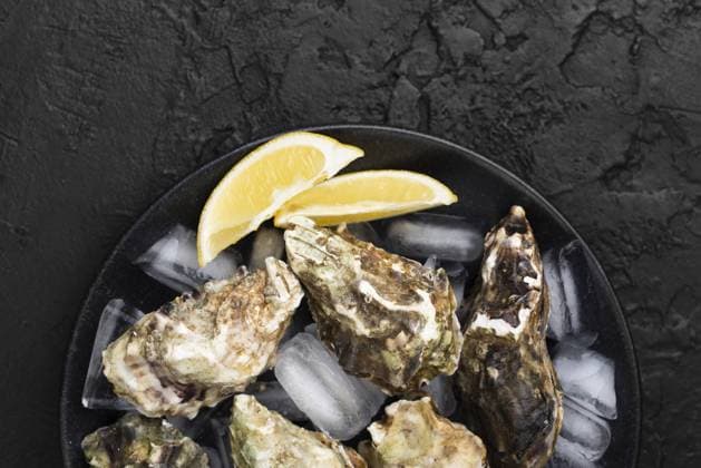 top view plate with oysters lemon slices. High quality and resolution beautiful photo concept top view plate with oysters lemon slices. Resolution and high quality beautiful photo Copyright: xZoonar.com OleksandrxLatkunx 17863235