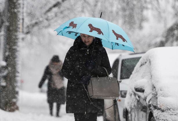 December 16, 2022, Ottawa, ON, CAN: A pedestrian uses their umbrella to shield themselves from the windblown snow as they make their way along a sidewalk in Ottawa, as a snowfall warning is in effect for the region, on Friday, Dec. 16, 2022. Ottawa CAN  - ZUMAc35_ 20221216_zaf_c35_010 Copyright: xJustinxTangx